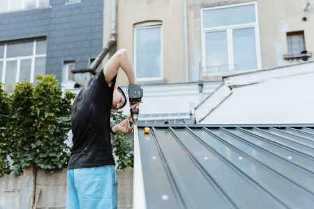 a-worker-guy-installs-a-roof-on-a-metal-shed-with-2025-09-18-00-20-04-utc