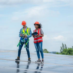 technician-checking-solar-panels-on-factory-roof-2025-01-08-04-12-50-utc 1