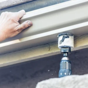 worker-attaching-aluminum-rain-gutter-to-fascia-of-2024-09-11-08-31-23-utc